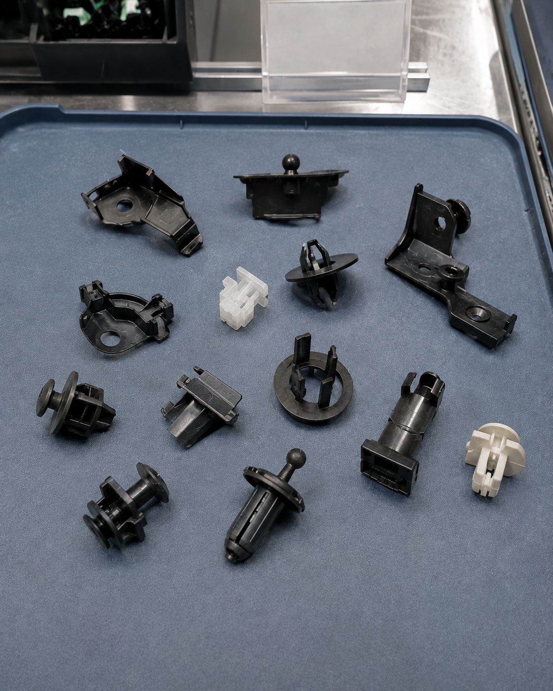 Injection-molded automotive under-hood components with reinforced ribs and mounting interfaces
