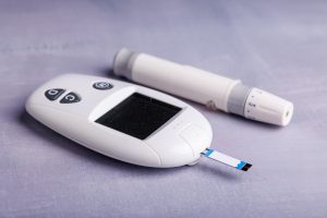 detailed,view,of,a,glucose,meter,on,a,concrete,table,